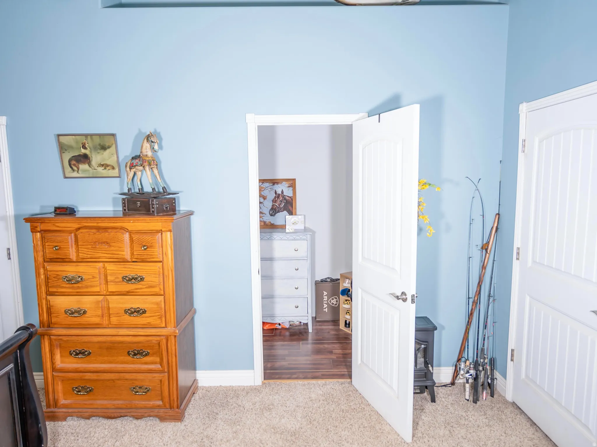 Bedroom featuring light carpet, a chandelier, a ceiling fan, and high vaulted ceiling
