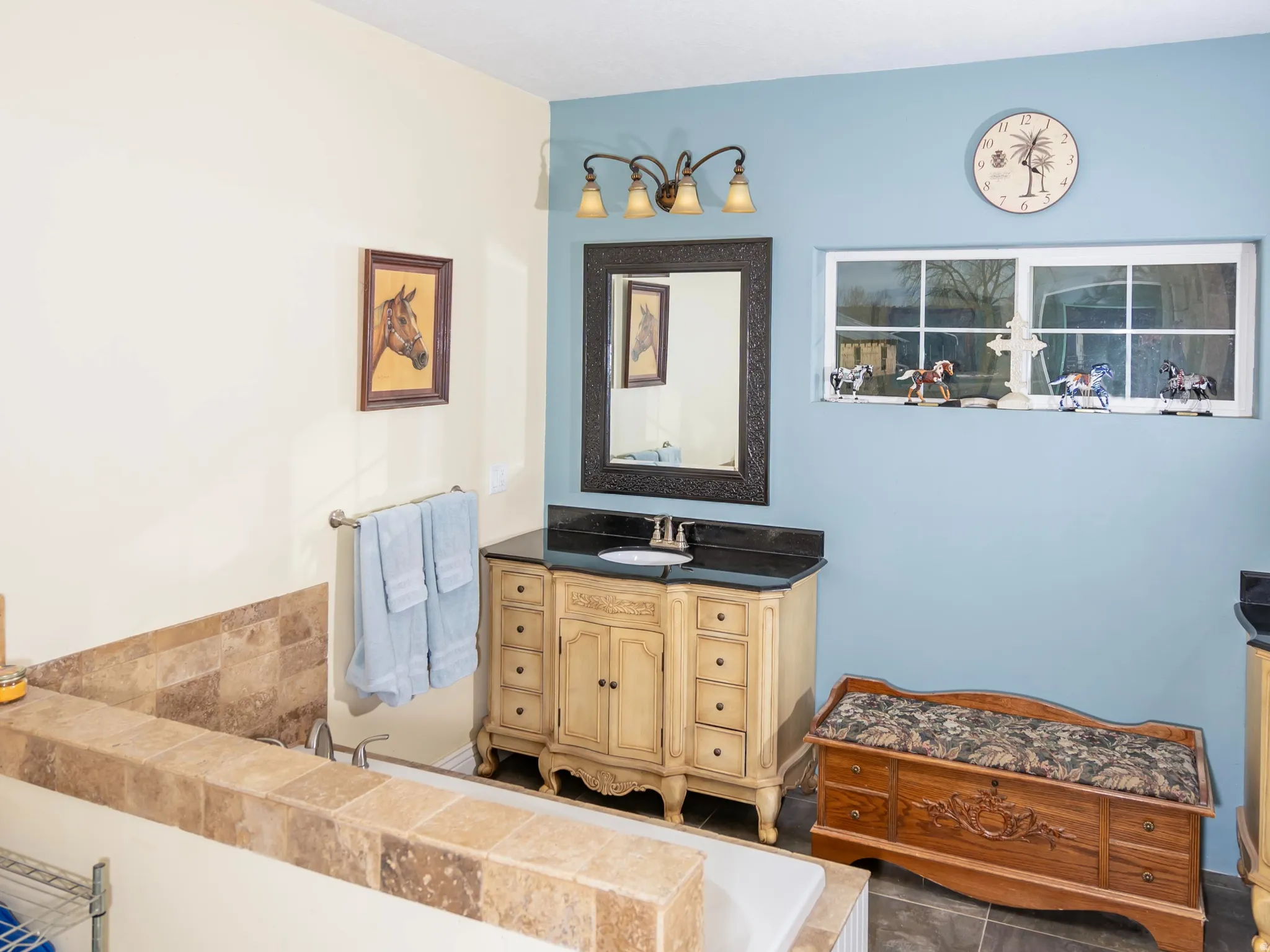 Full bathroom featuring vanity and tiled bath