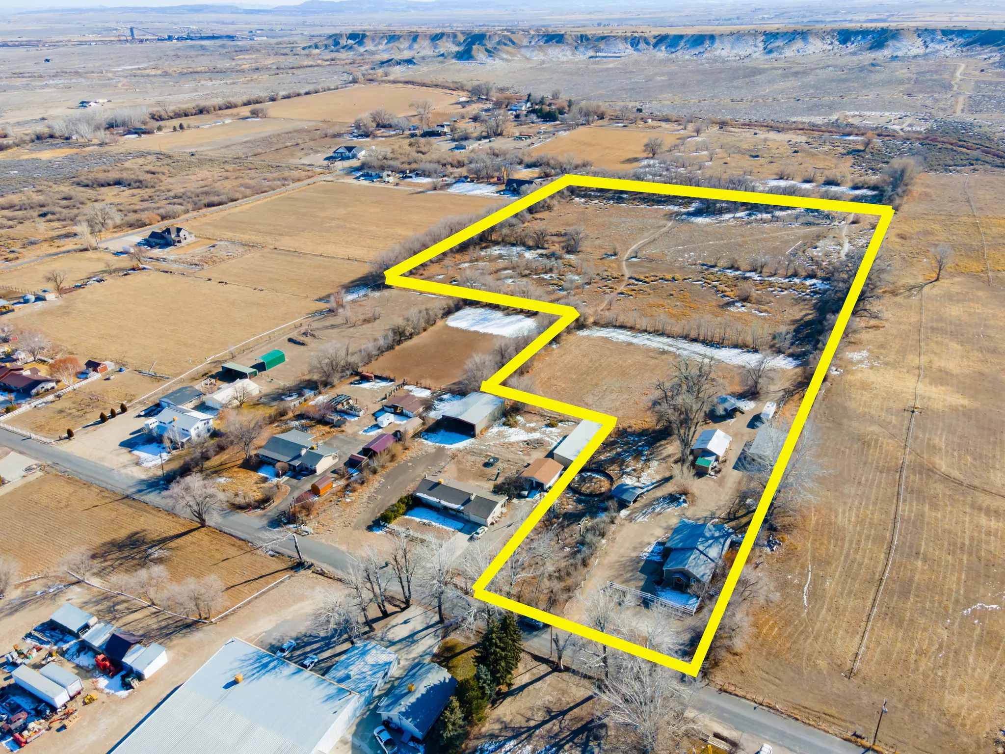 Aerial view of sparsely populated area featuring a desert landscape and property boundaries highlighted