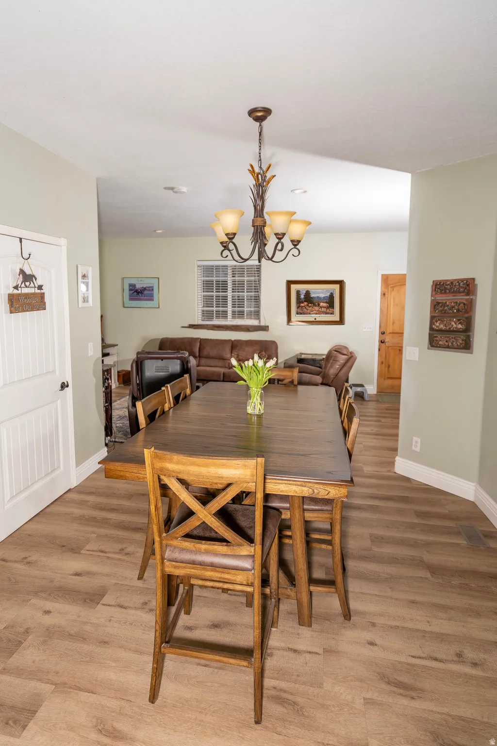 Dining space with a chandelier and light wood-style flooring