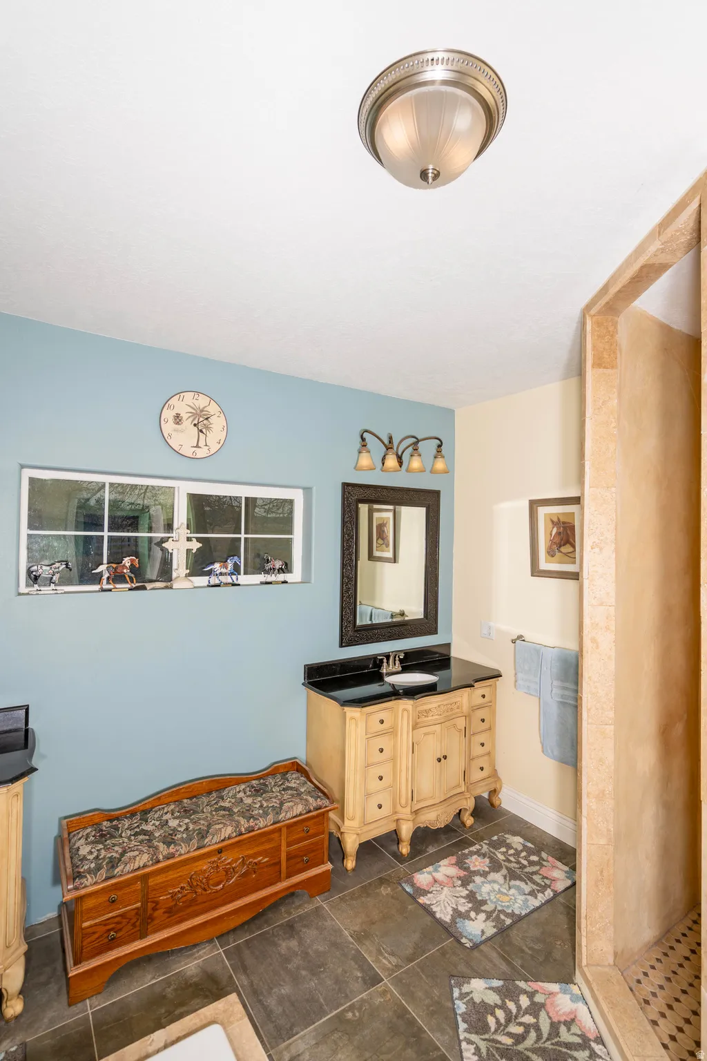 Full bathroom with vanity and baseboards