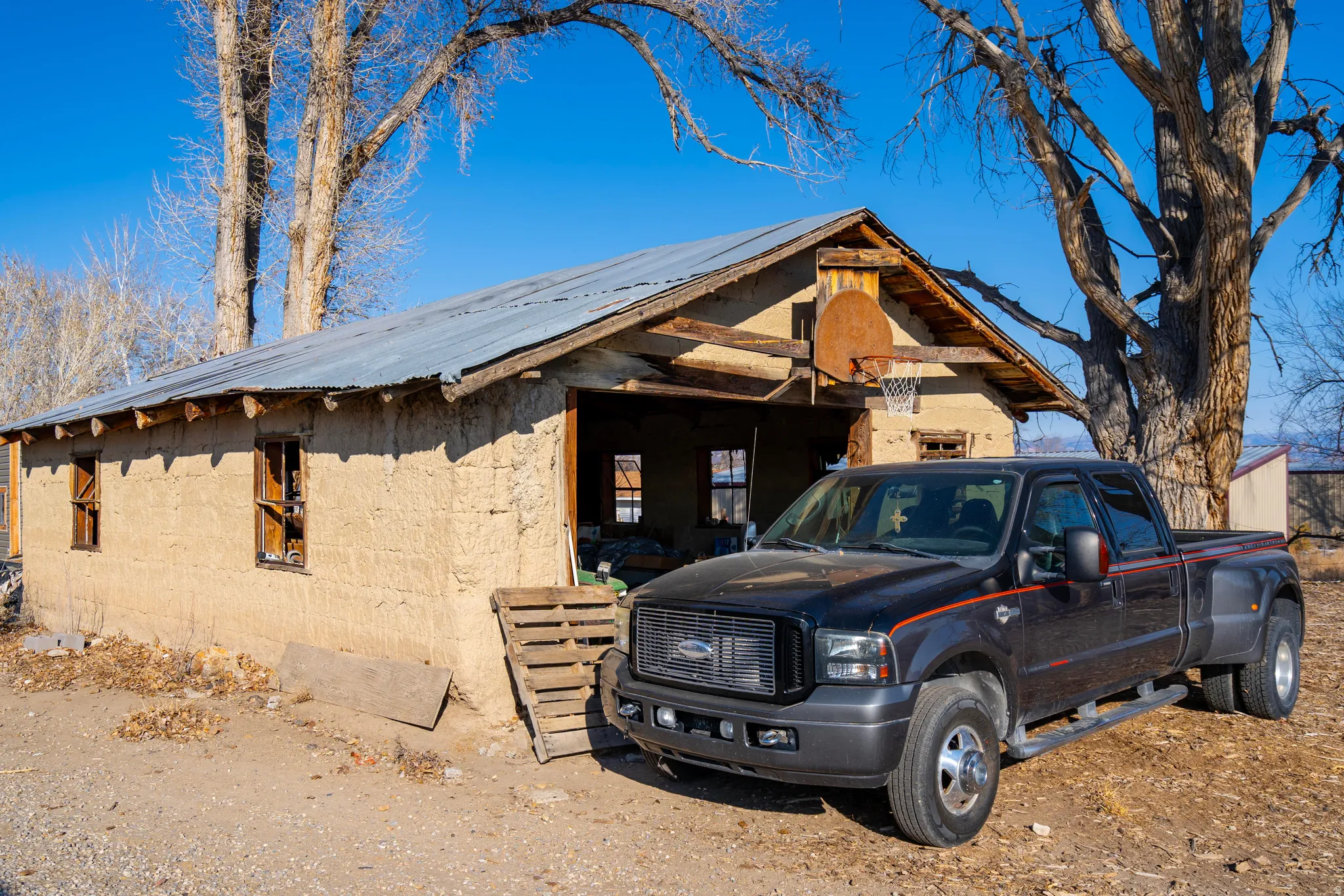 View of property exterior featuring concrete block siding, a metal roof, and an outdoor structure