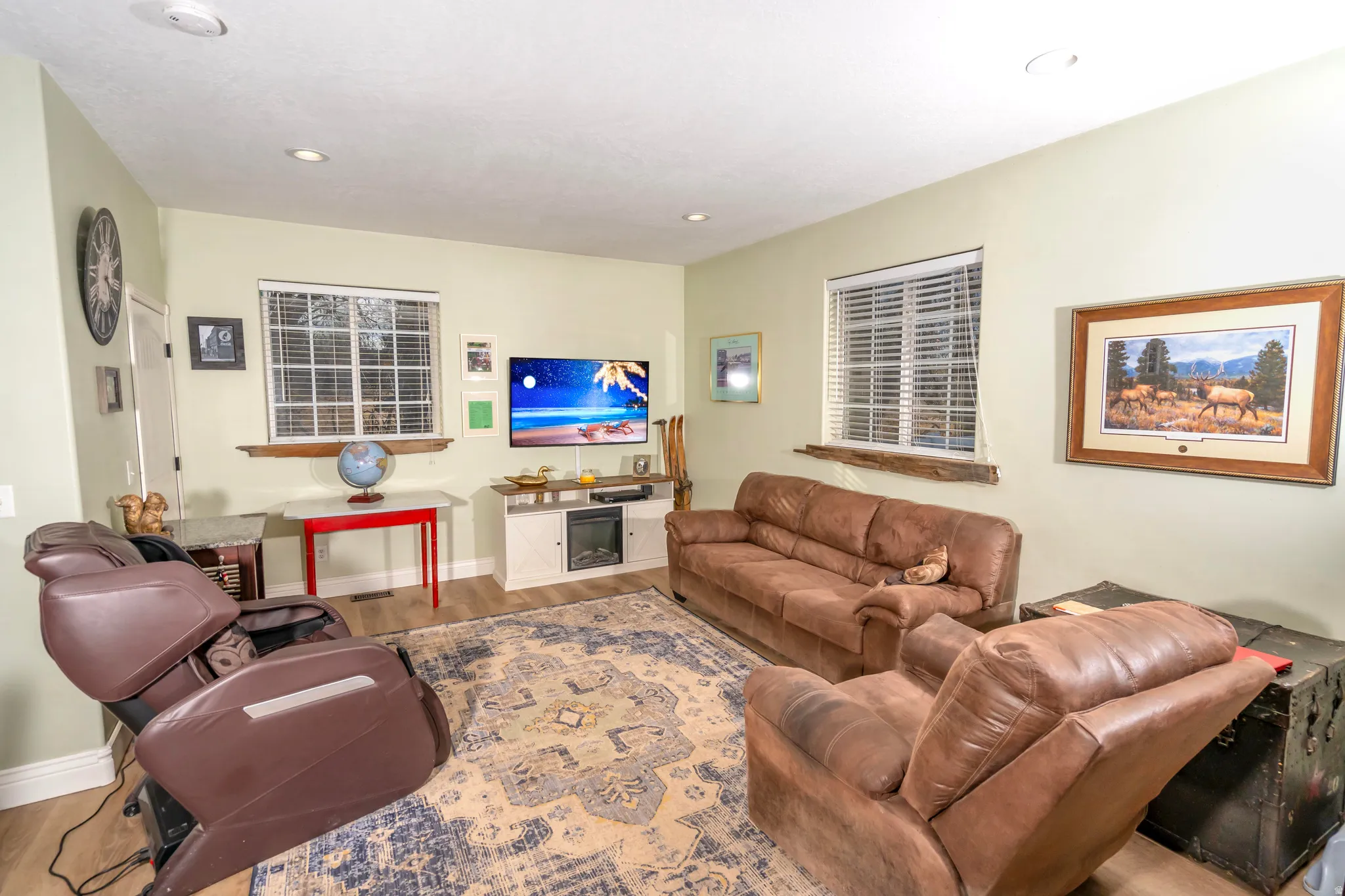 Living area featuring wood finished floors and recessed lighting