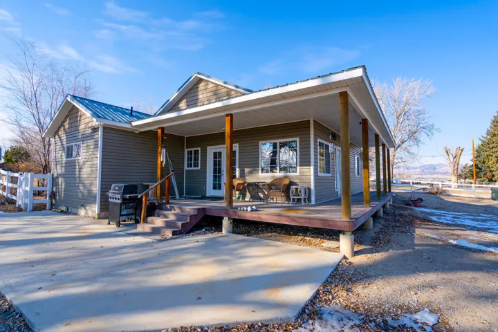 View of front of property featuring covered porch and a metal roof