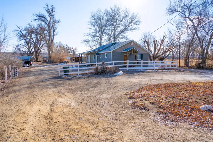 View of front of property with a fenced front yard and a porch