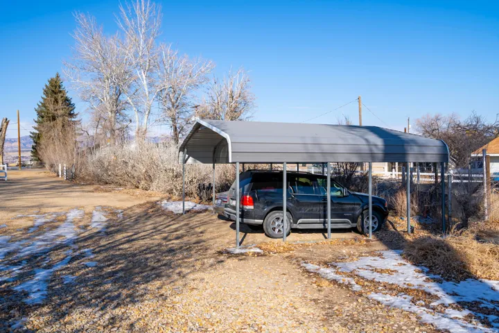 View of car parking featuring a detached carport