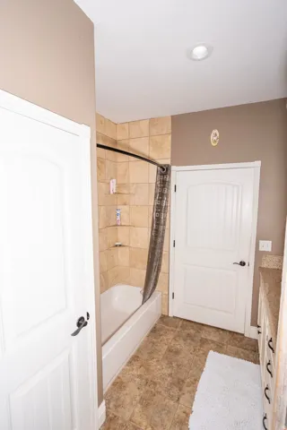 Full bathroom featuring shower / tub combo and vanity