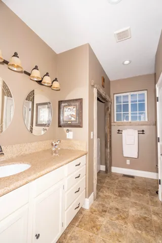 Full bath featuring vanity and curtained shower