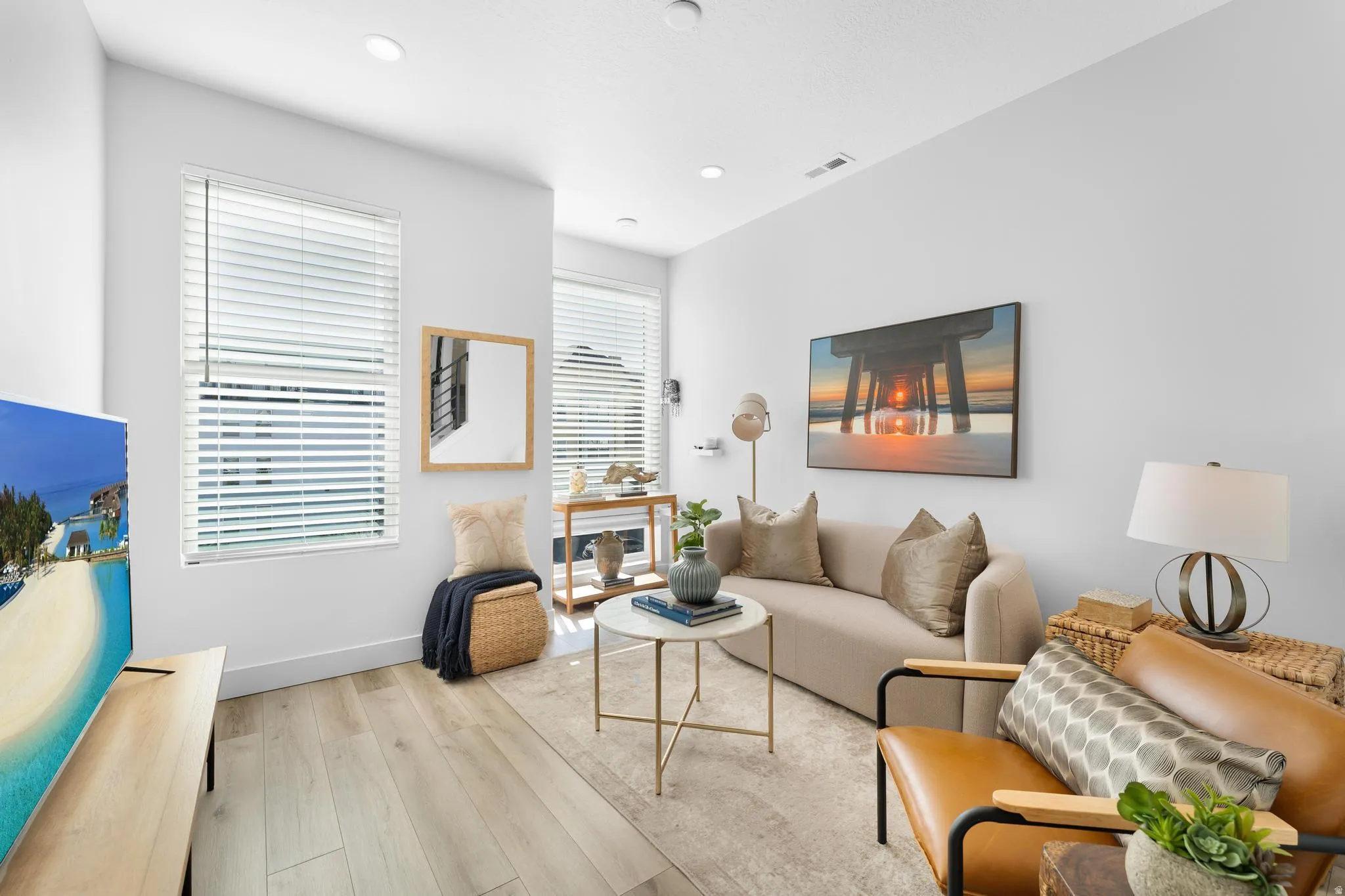 Living area featuring light wood finished floors and recessed lighting