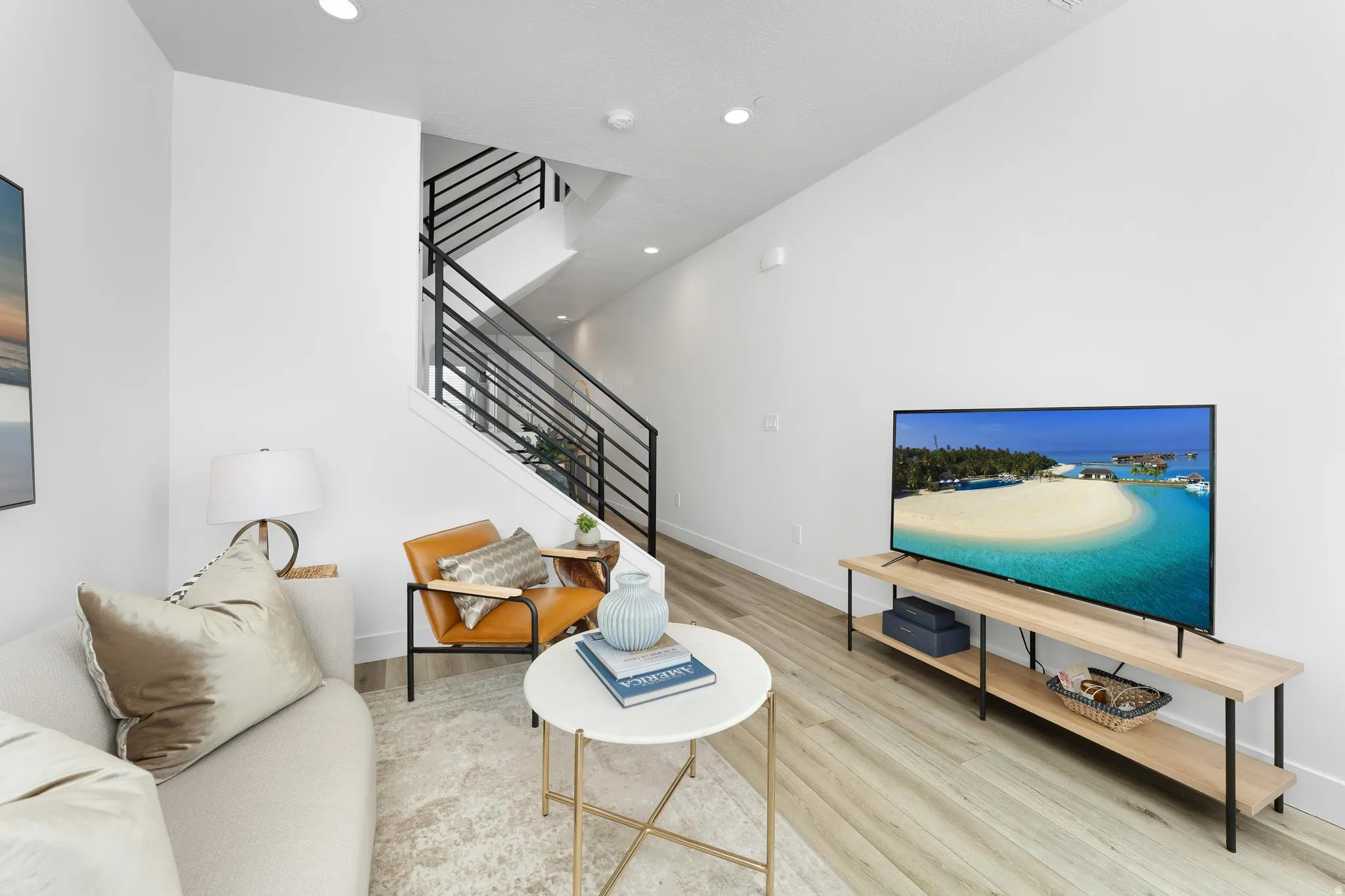 Living area featuring stairs and light wood finished floors