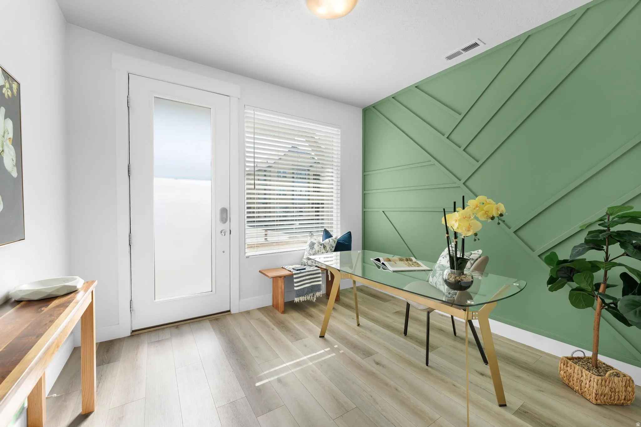 Home office featuring light wood finished floors and baseboards