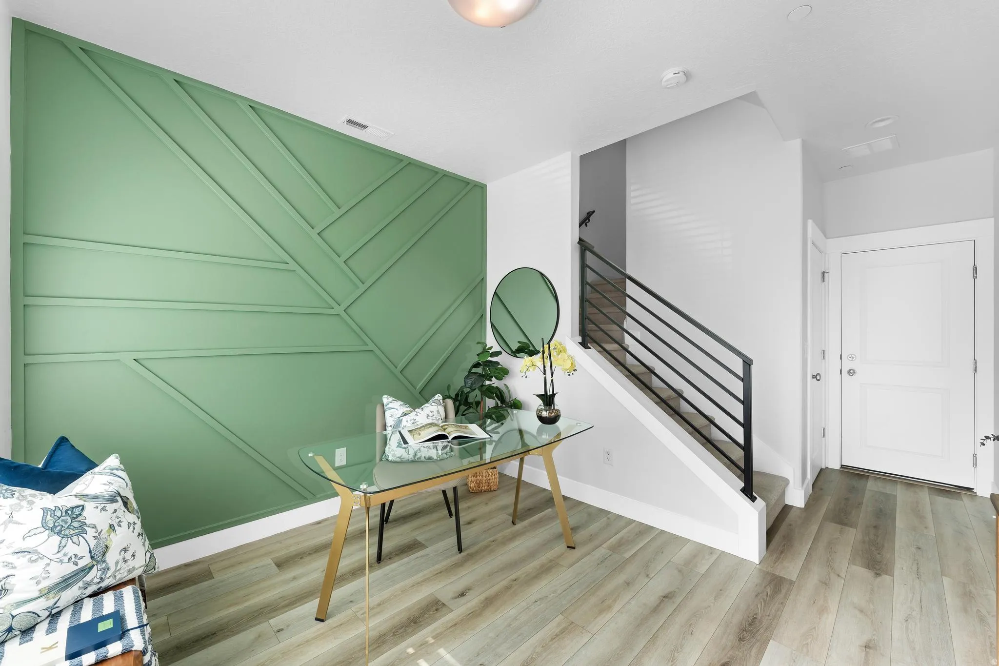 Home office featuring a decorative wall and light wood-style floors