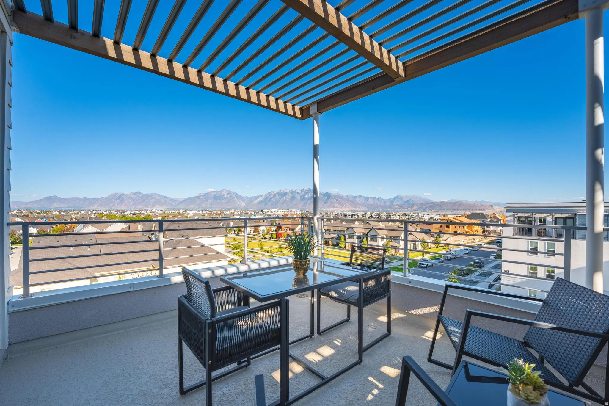 Balcony featuring a residential view, a mountain view, and a pergola