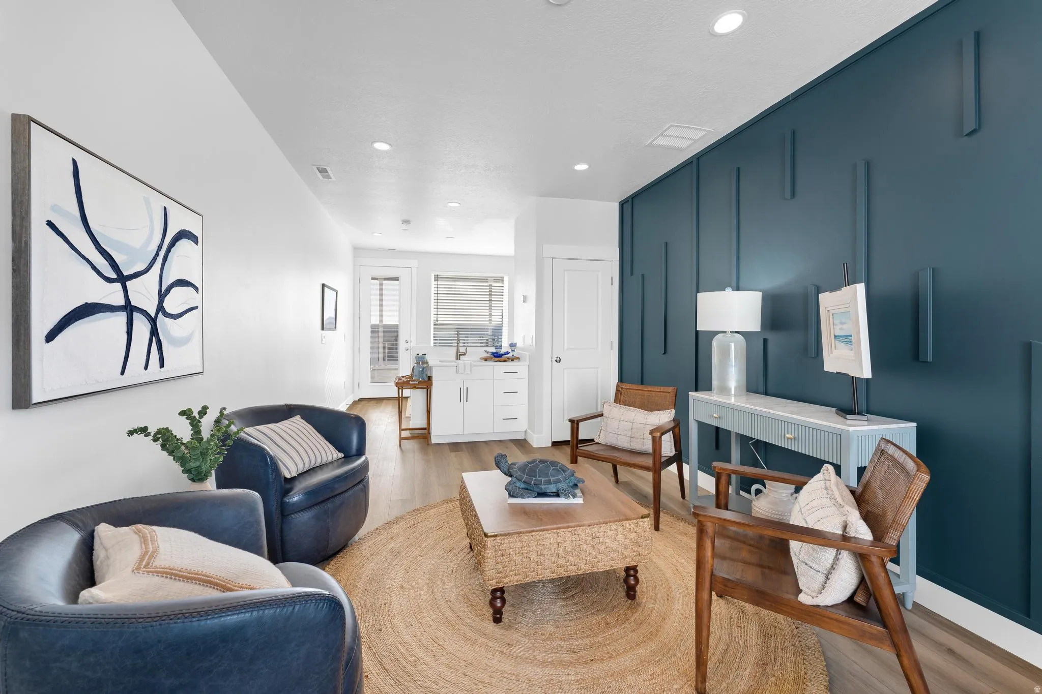 Living area featuring light wood-style flooring and recessed lighting