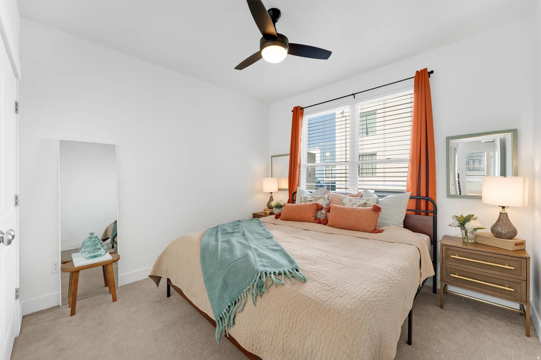 Bedroom featuring ceiling fan, light carpet, and lofted ceiling