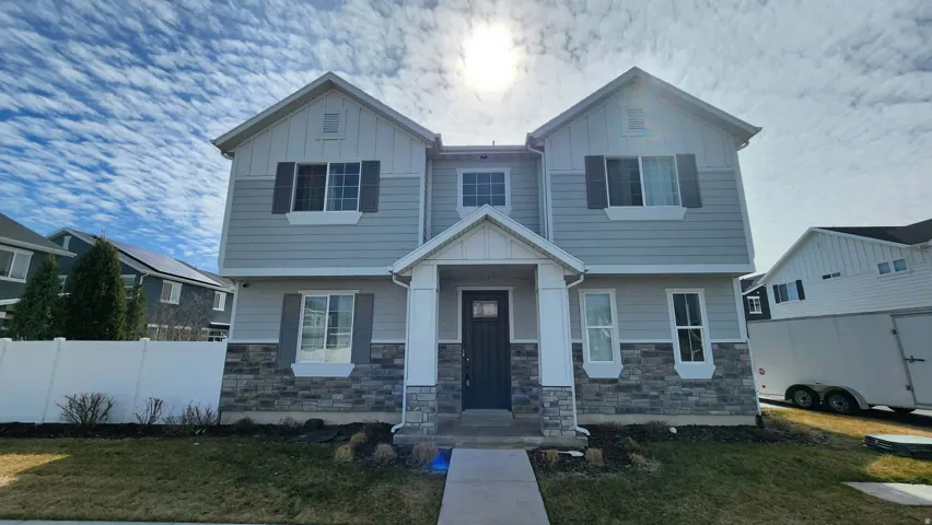 View of front of property featuring board and batten siding and stone siding