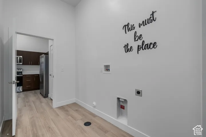 Laundry room with access to garage and community breezeway.