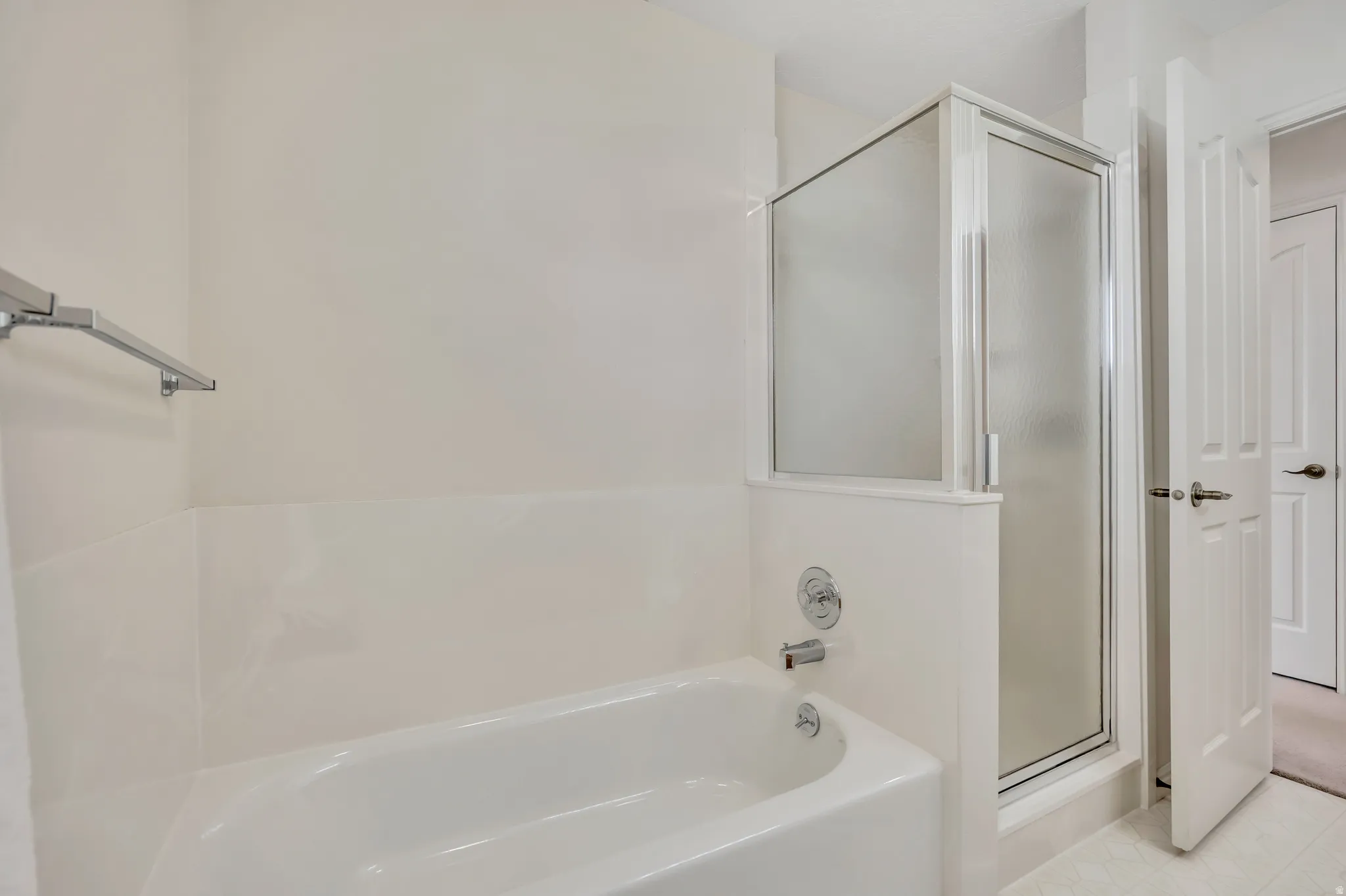 Bathroom featuring a shower stall and a garden tub