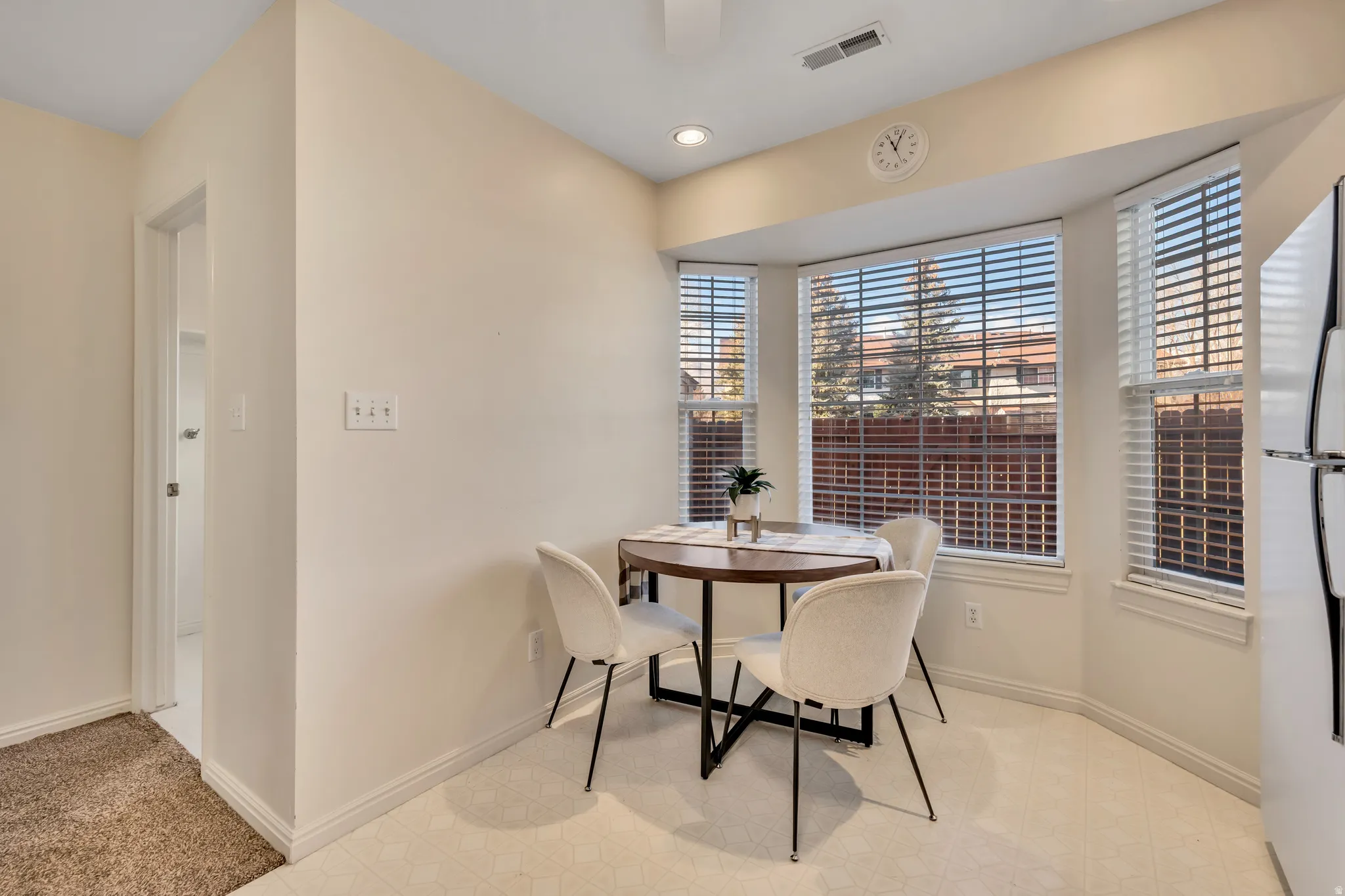 Dining room featuring light colored carpet and recessed lighting