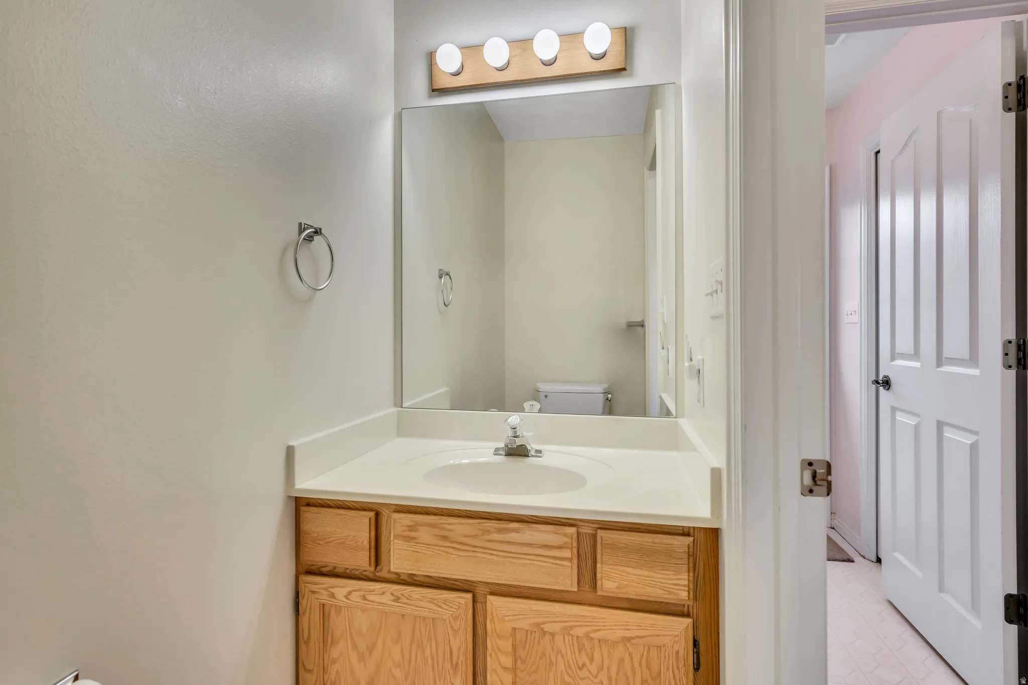 Bathroom with vanity and light flooring