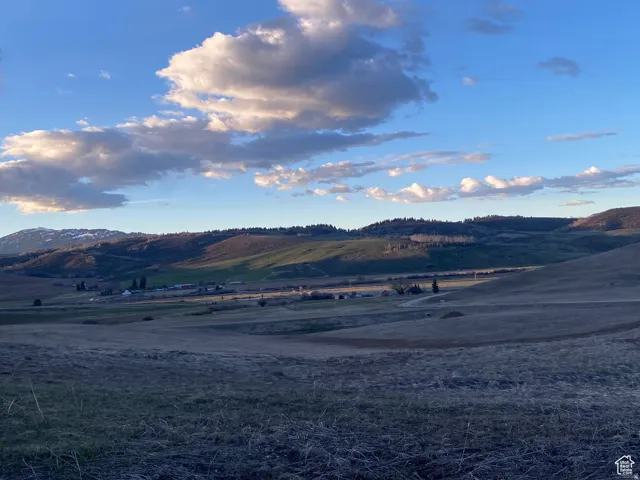 View of mountain backdrop with rural landscape