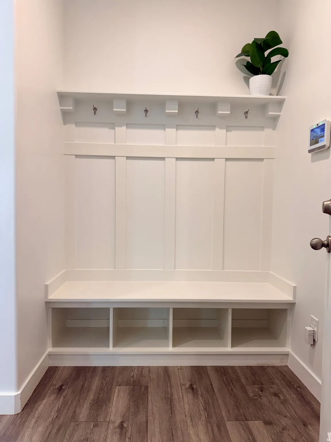 Mudroom with dark wood finished floors