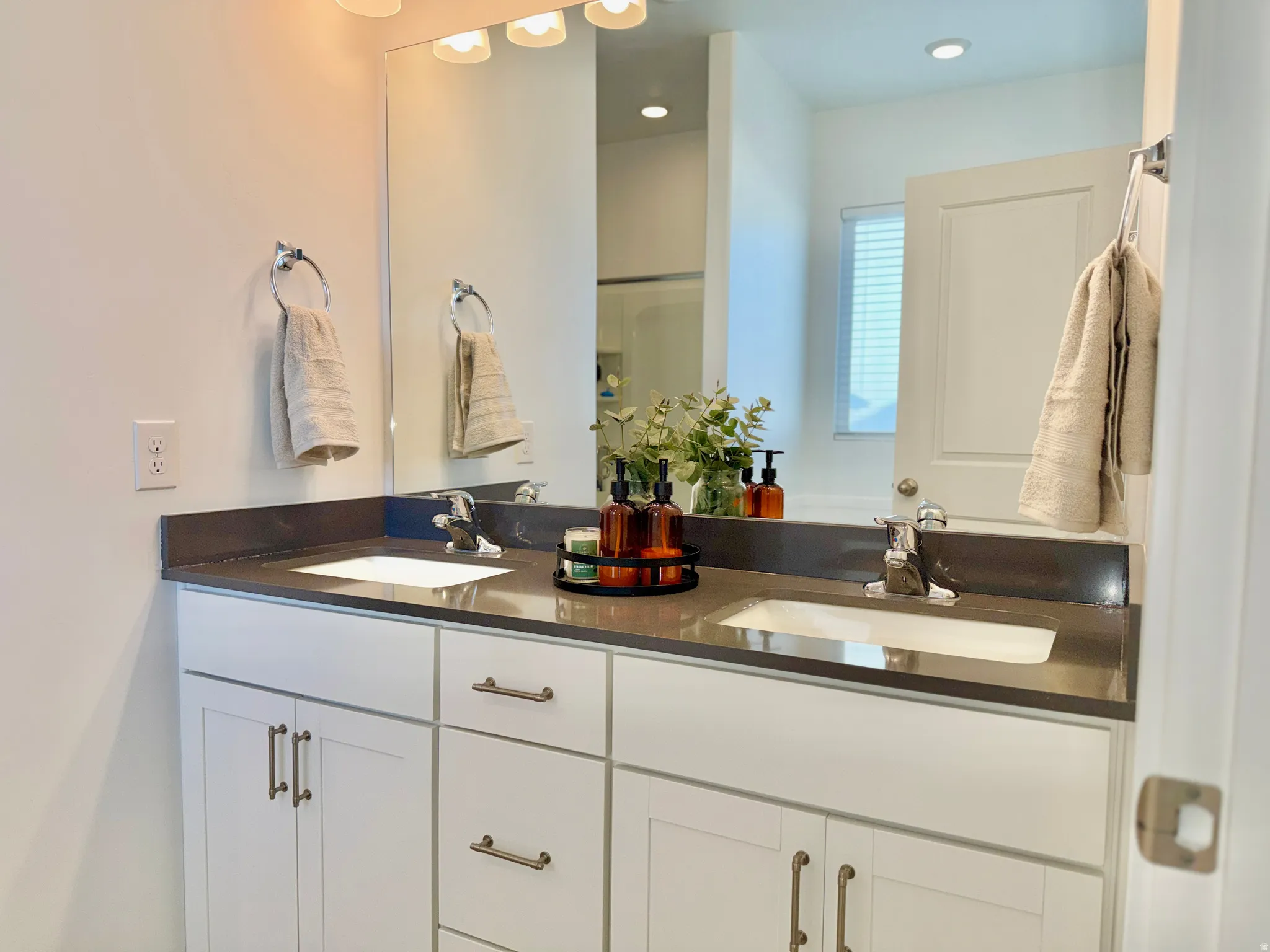 Full bath featuring double vanity and recessed lighting