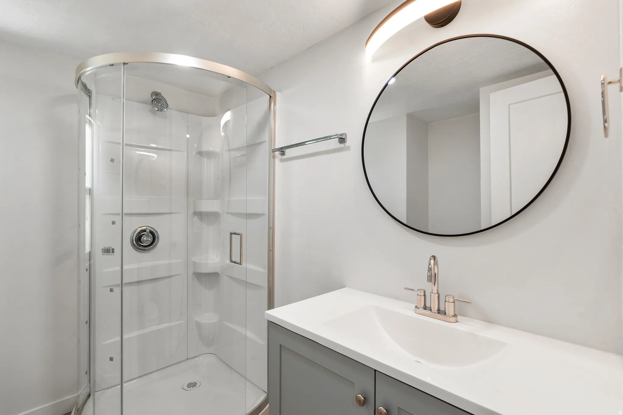 Bathroom featuring vanity and a shower stall