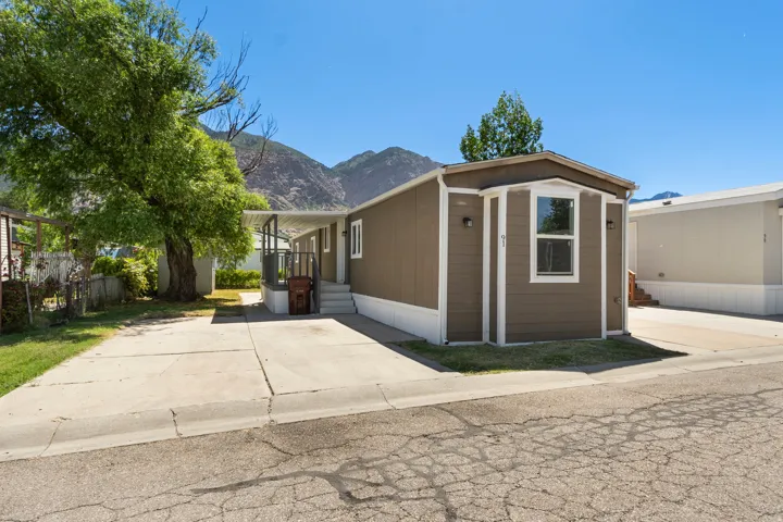 Manufactured / mobile home with a mountain view and a porch