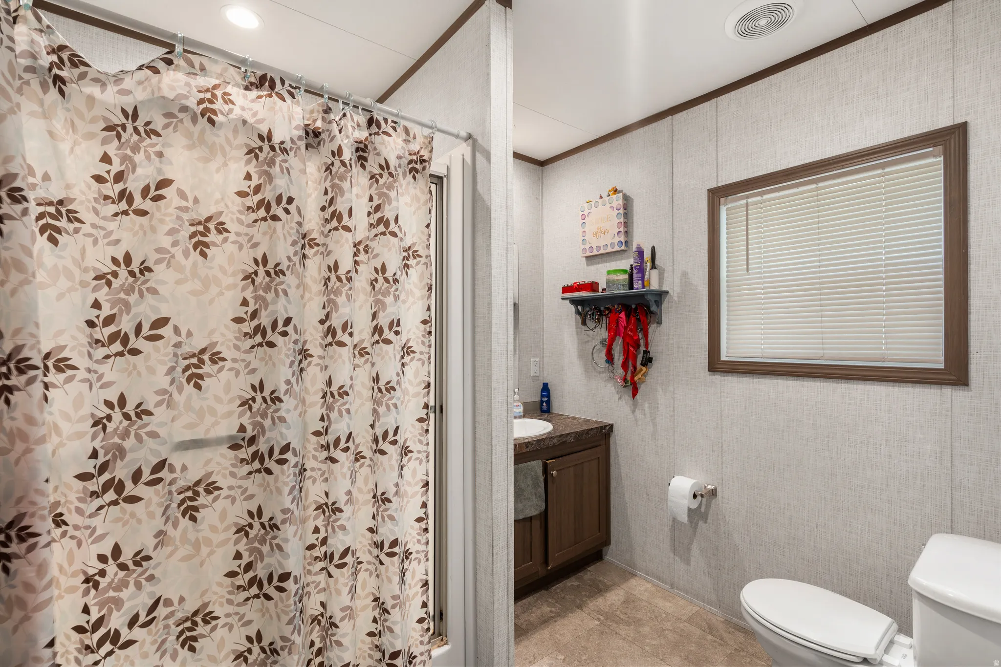 Full bathroom with a shower with curtain, vanity, and ornamental molding
