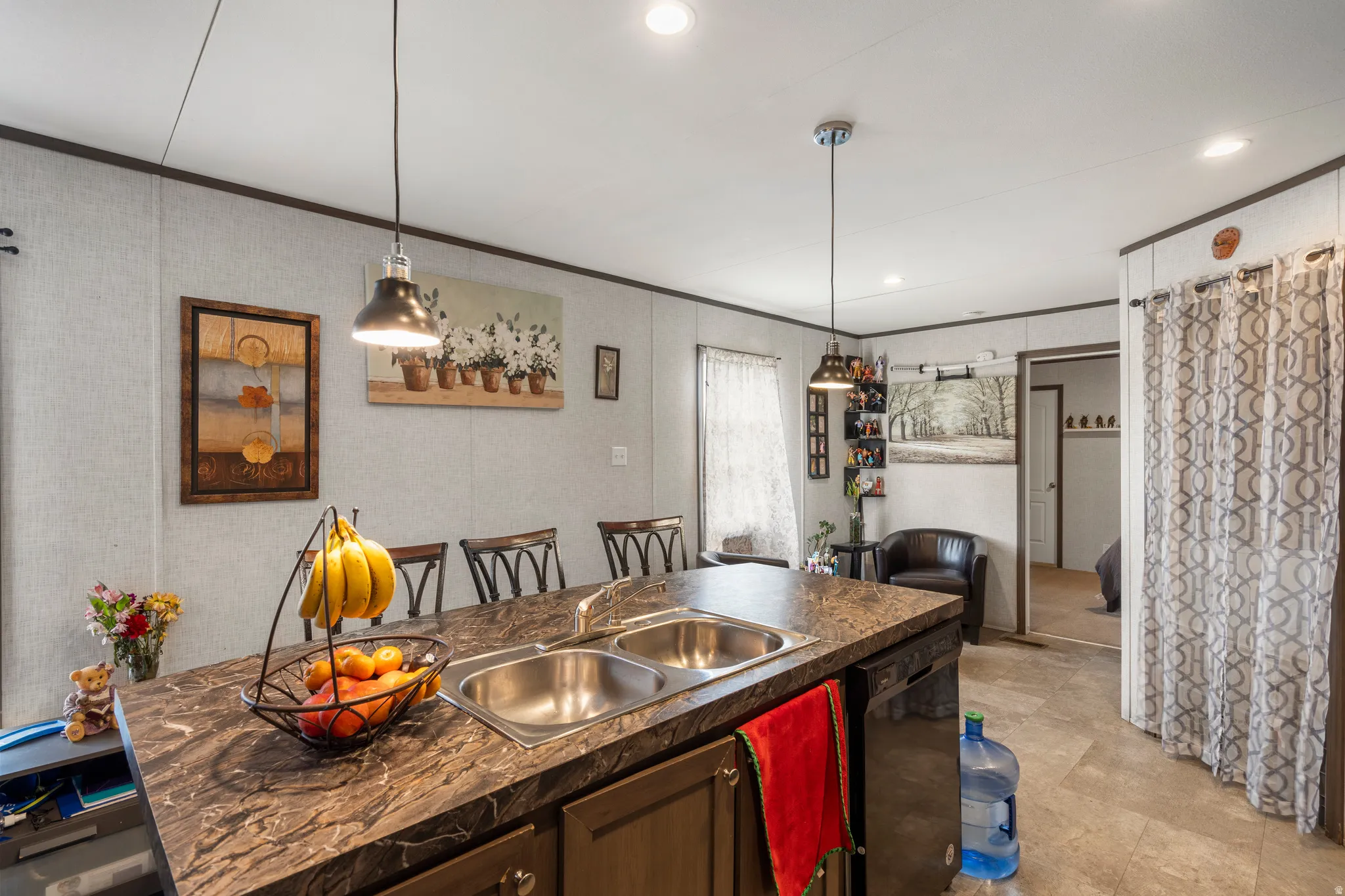 Kitchen featuring dark countertops, dishwasher, hanging light fixtures, recessed lighting, and wallpapered walls