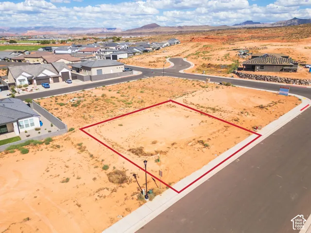 Expansive lot outlined in red, featuring a paved street frontage and established street lights