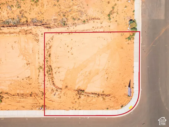 Corner lot with a paved street and concrete sidewalk