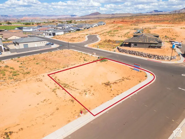 Corner lot with direct street access, surrounded by developing residential properties and distant mountain ranges