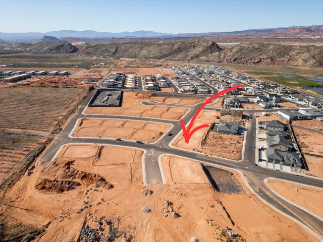 Aerial overview of property's location with a mountain backdrop and nearby suburban area