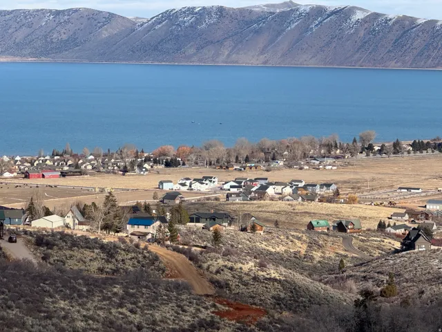 Water view with a mountainous background and nearby suburban area