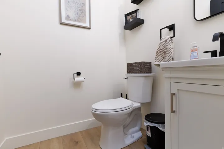 Half bathroom featuring vanity and light wood-style flooring