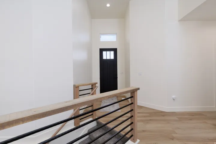 Entryway with light wood finished floors, recessed lighting, and a high ceiling