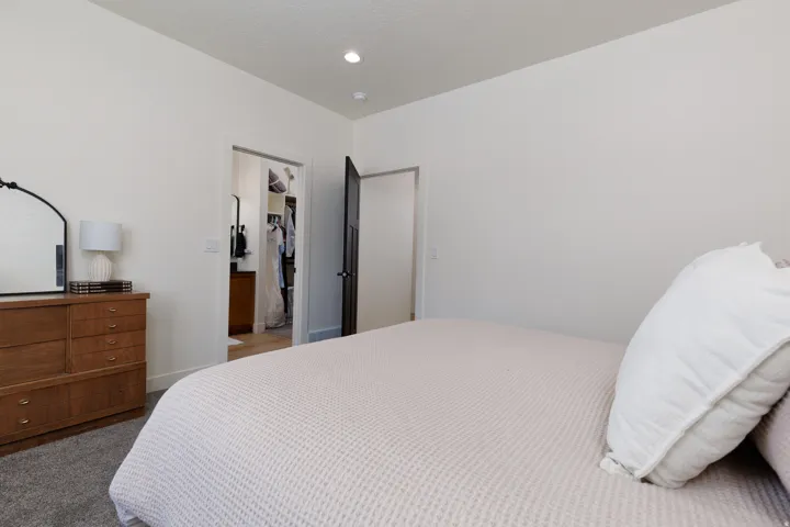 Carpeted bedroom featuring a spacious closet and recessed lighting