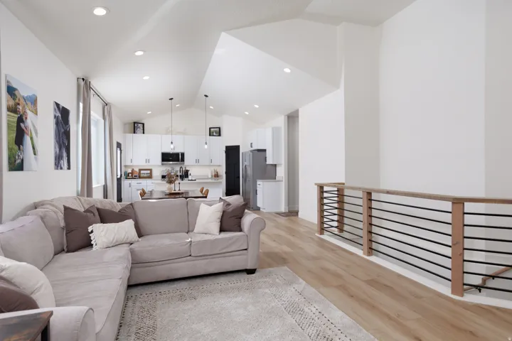 Living area featuring light wood-style floors and high vaulted ceiling