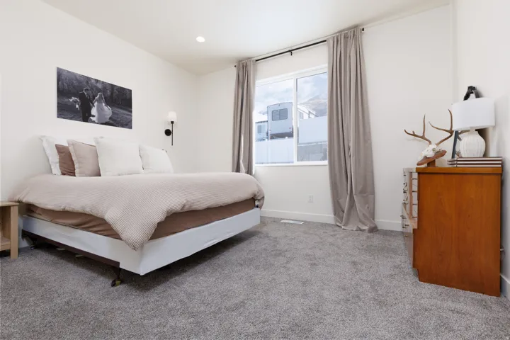 Bedroom featuring light carpet and recessed lighting