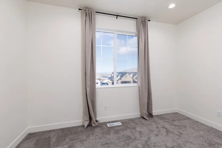 Empty room with carpet and recessed lighting