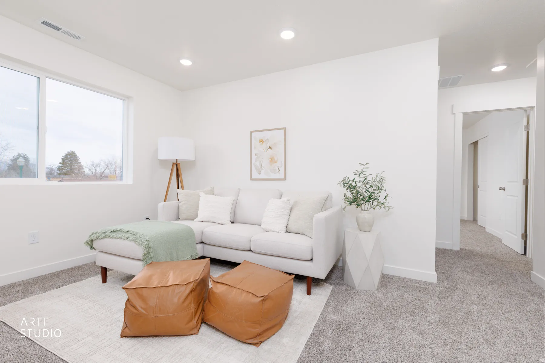 Living area with carpet floors and recessed lighting