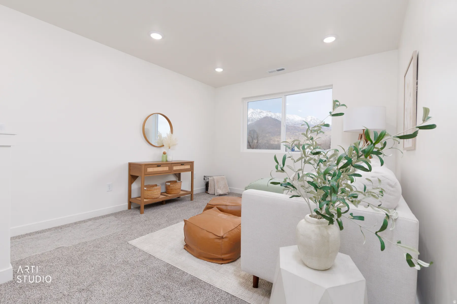 Living area with carpet floors and recessed lighting