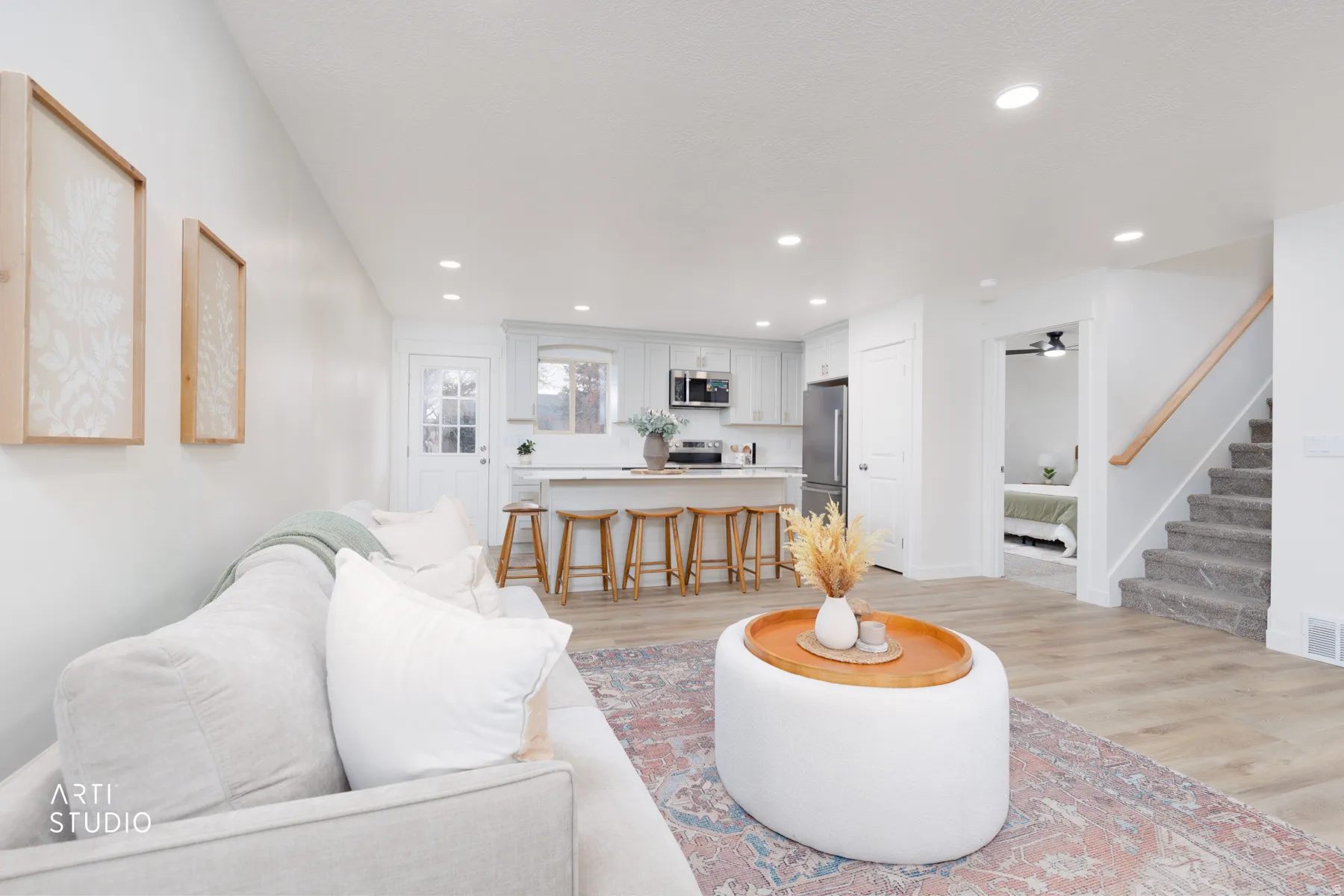Living area with light wood-style flooring and recessed lighting