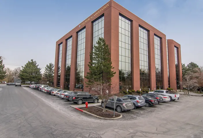 View of building exterior with uncovered parking