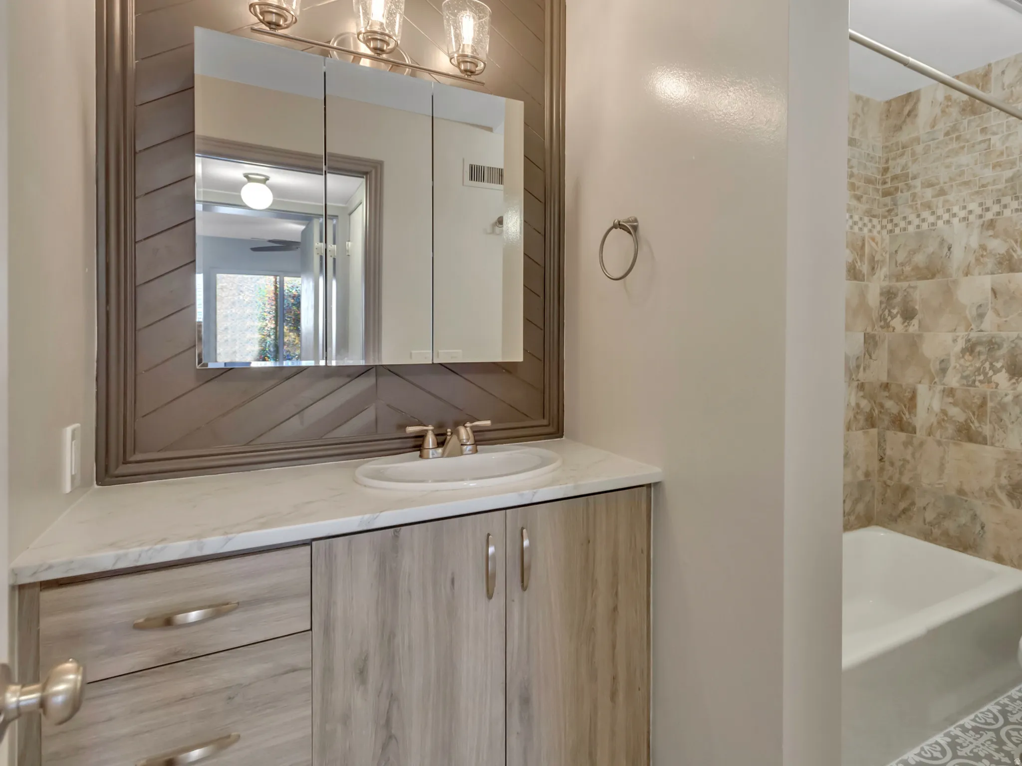 Full bath featuring vanity and  shower combination