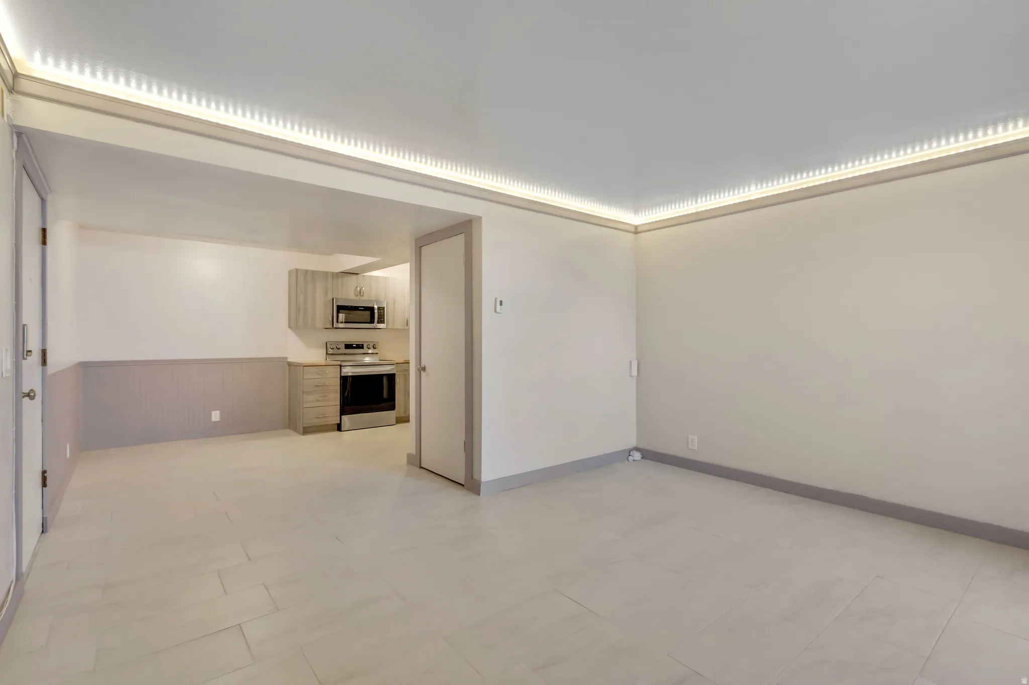 Spare room featuring wainscoting