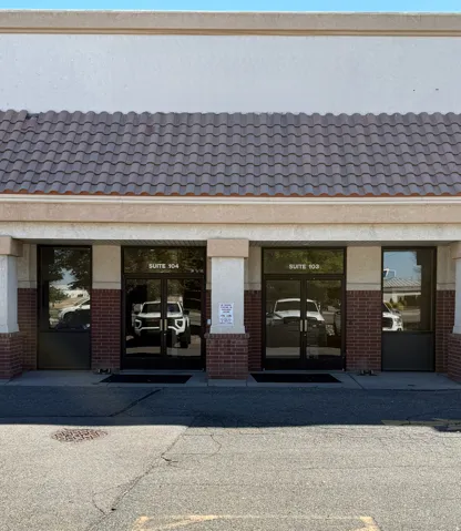 Doorway to property featuring french doors, brick siding, and a tiled roof