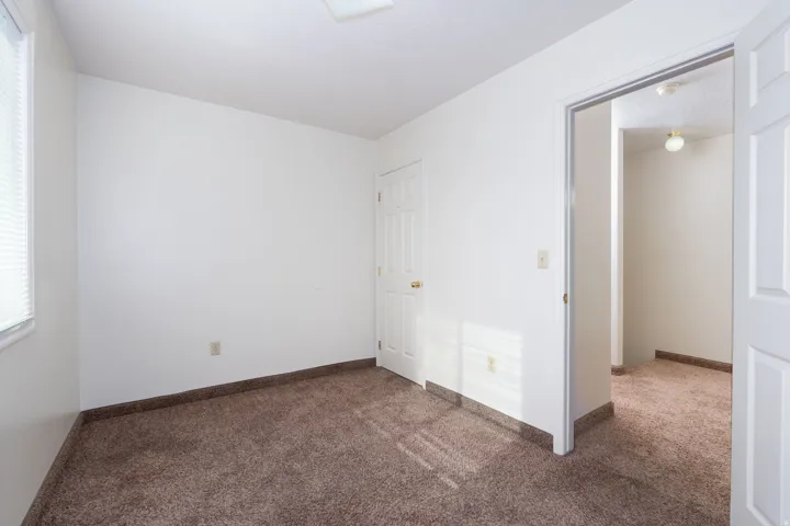 Unfurnished bedroom with carpet and baseboards